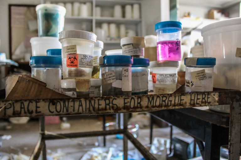 containers shown on a shelf, that reads "place containers for morgue here"